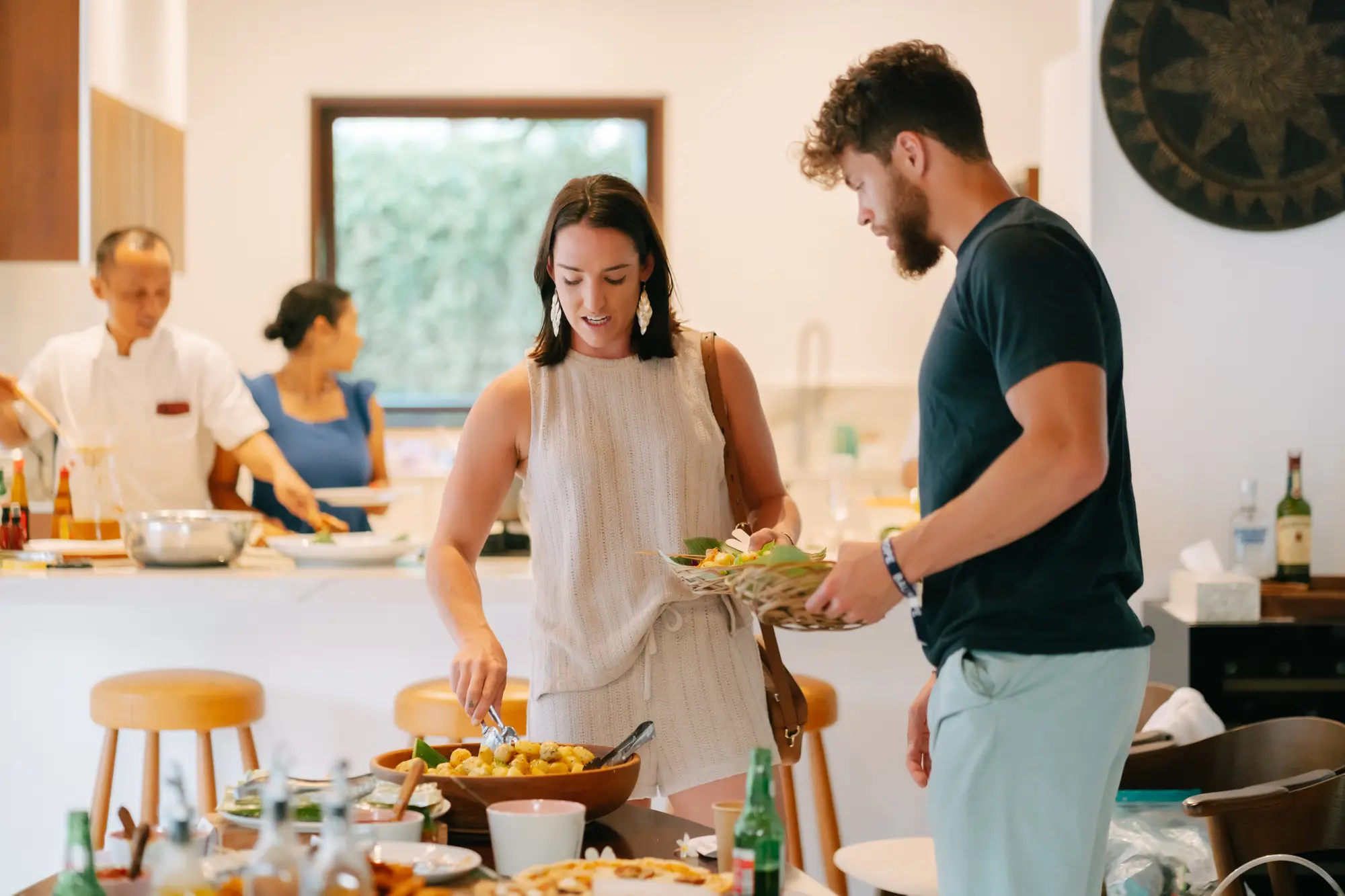 Guests cooking together in the villa kitchen
