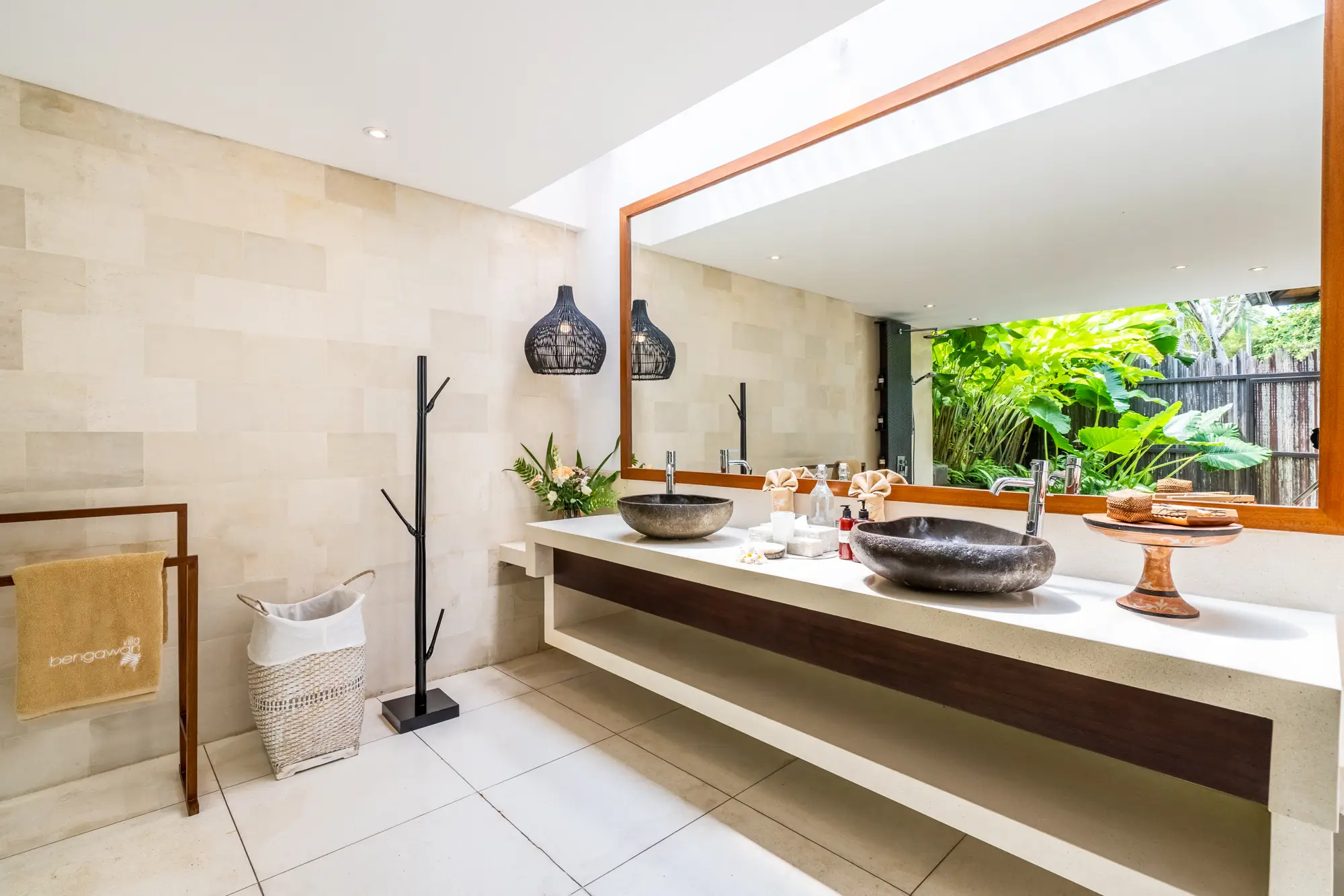 A bathroom with a stone basin and a garden window