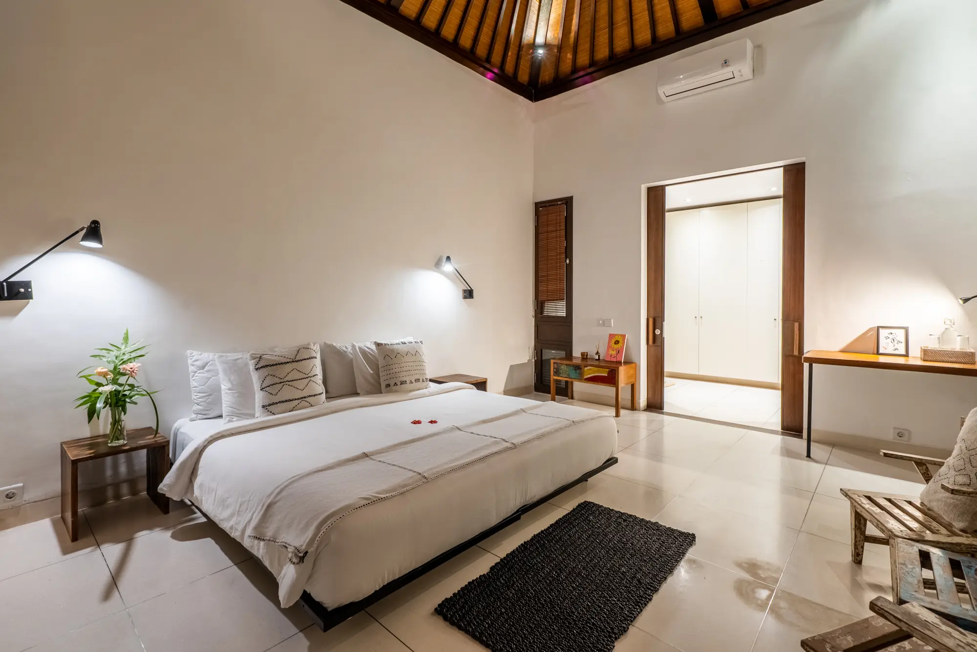 A bright bedroom suite with a writing desk