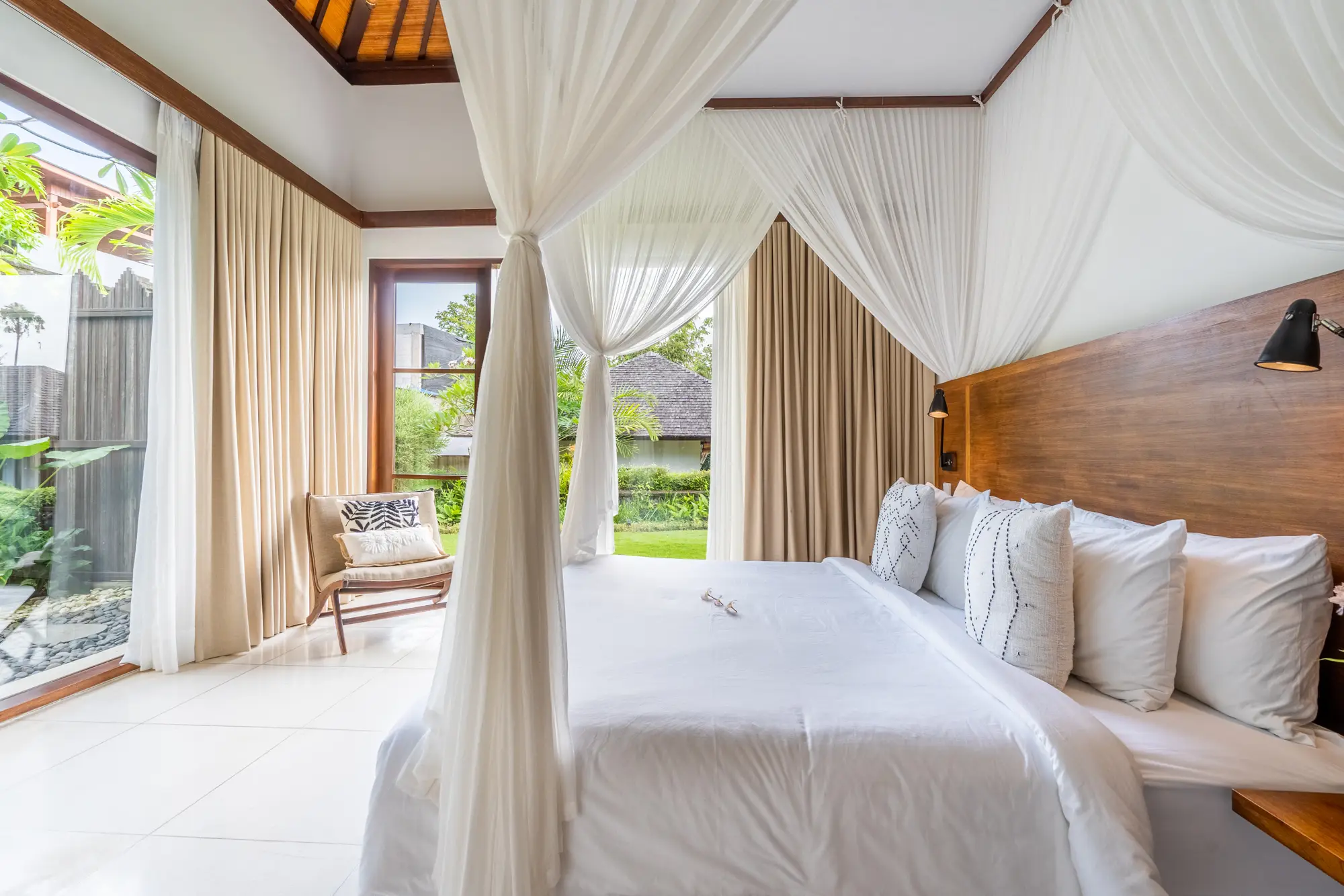 A four-poster bed under a high timber roof