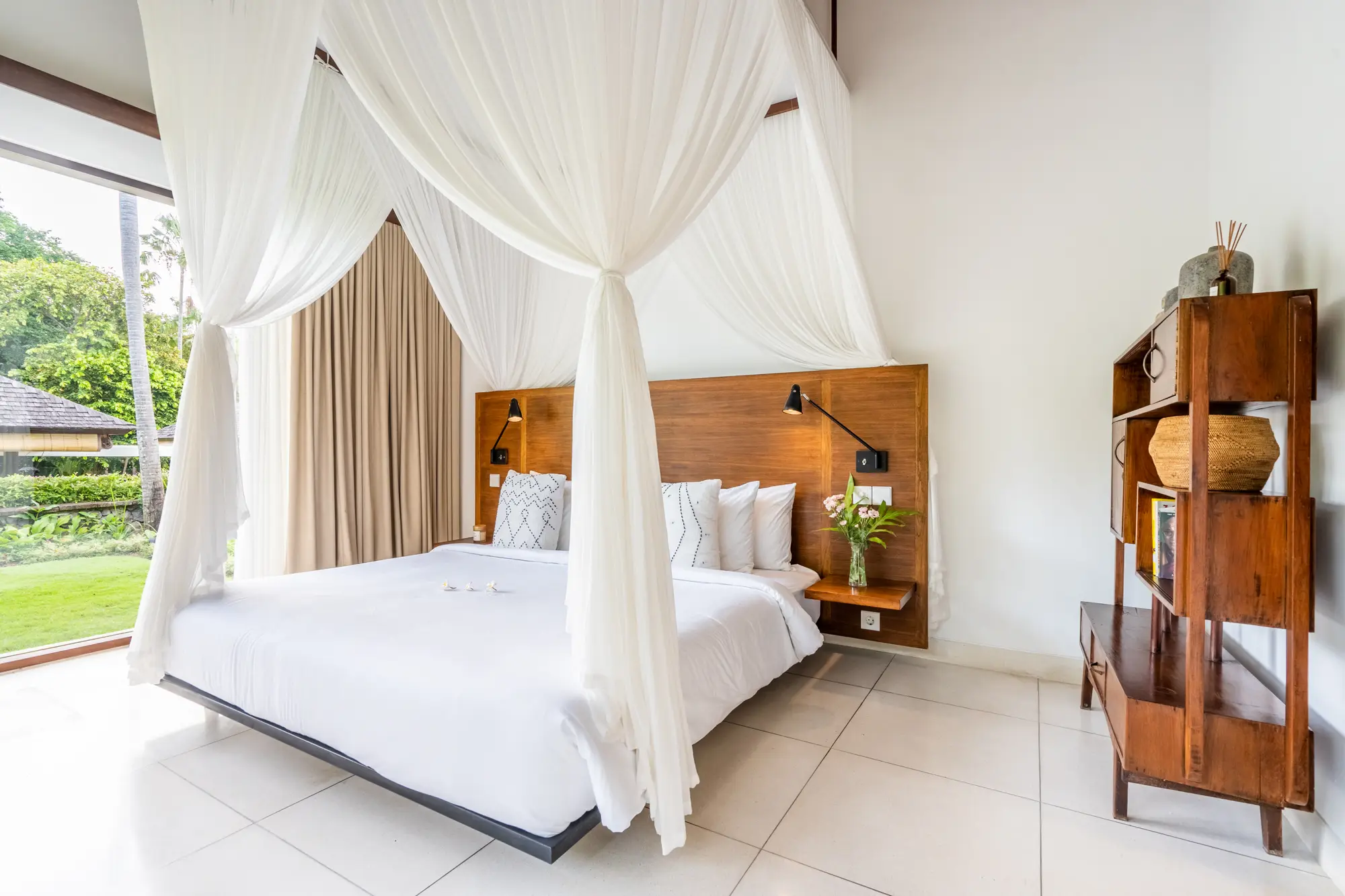A four-poster bed with white netting