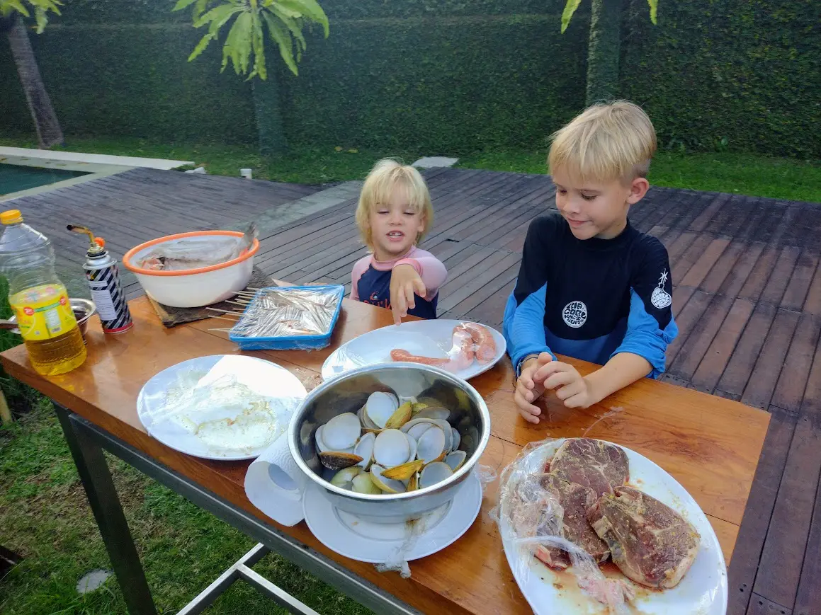 Two boys eating breakfast at the garden table