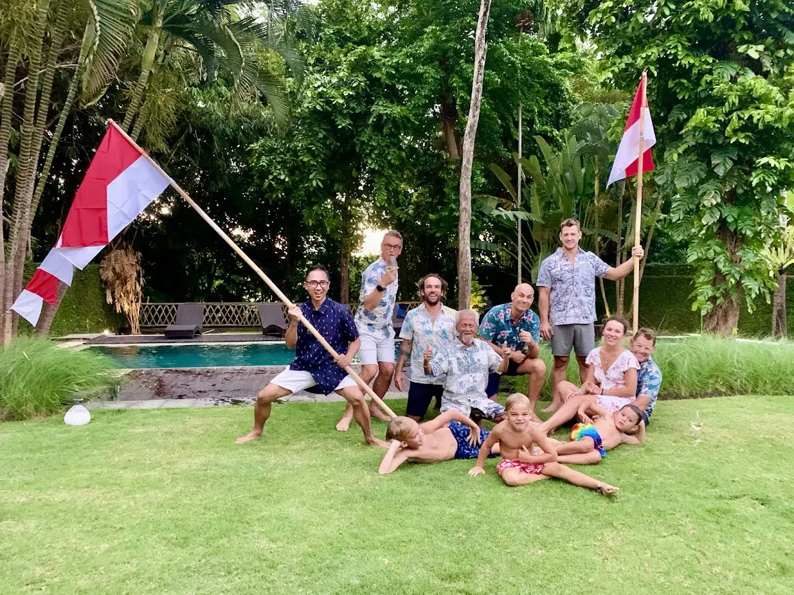 A large group on the lawn with Indonesian flags
