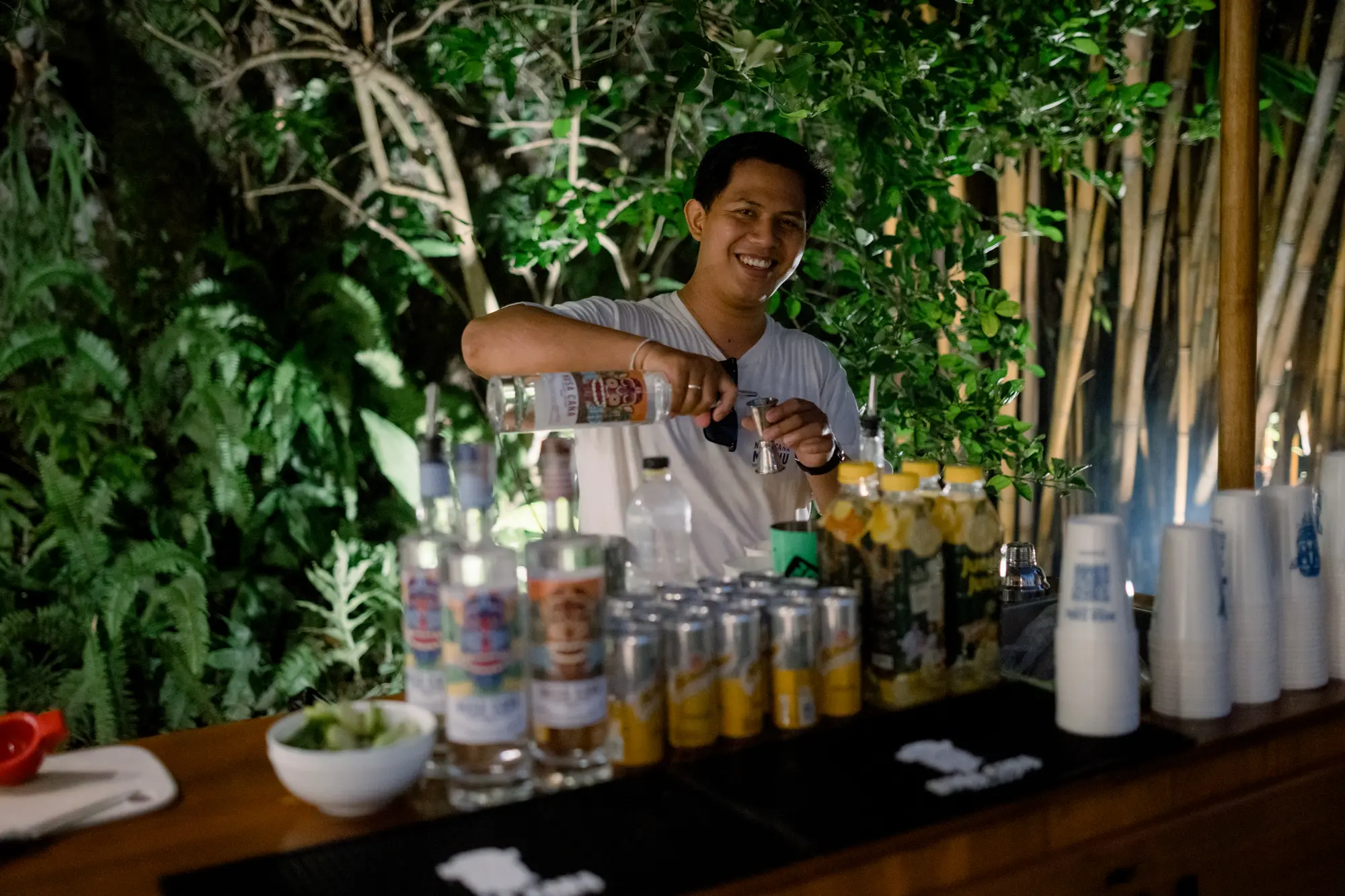 A bartender preparing drinks at an outdoor bar