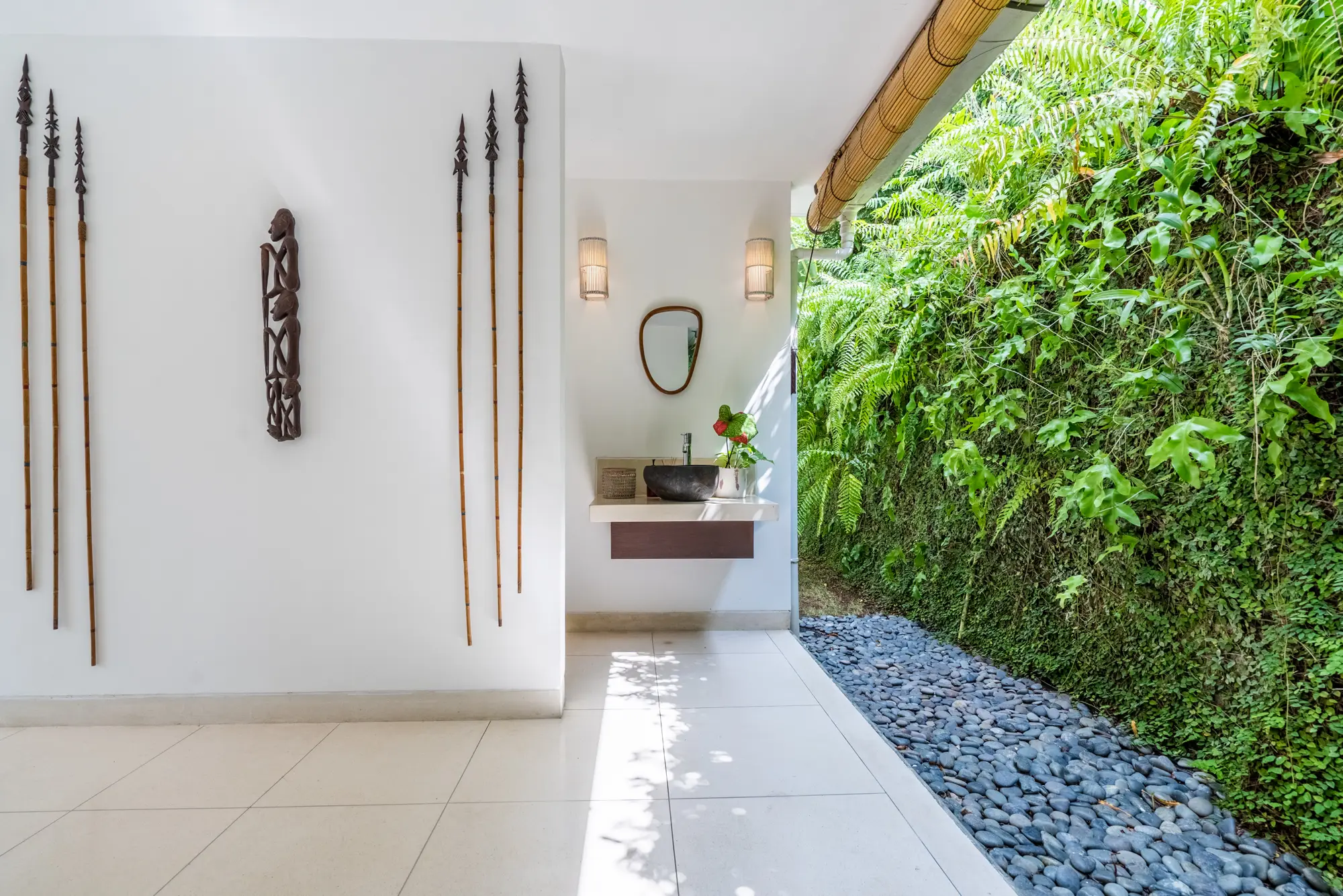 An open-air shower walk with tropical plants