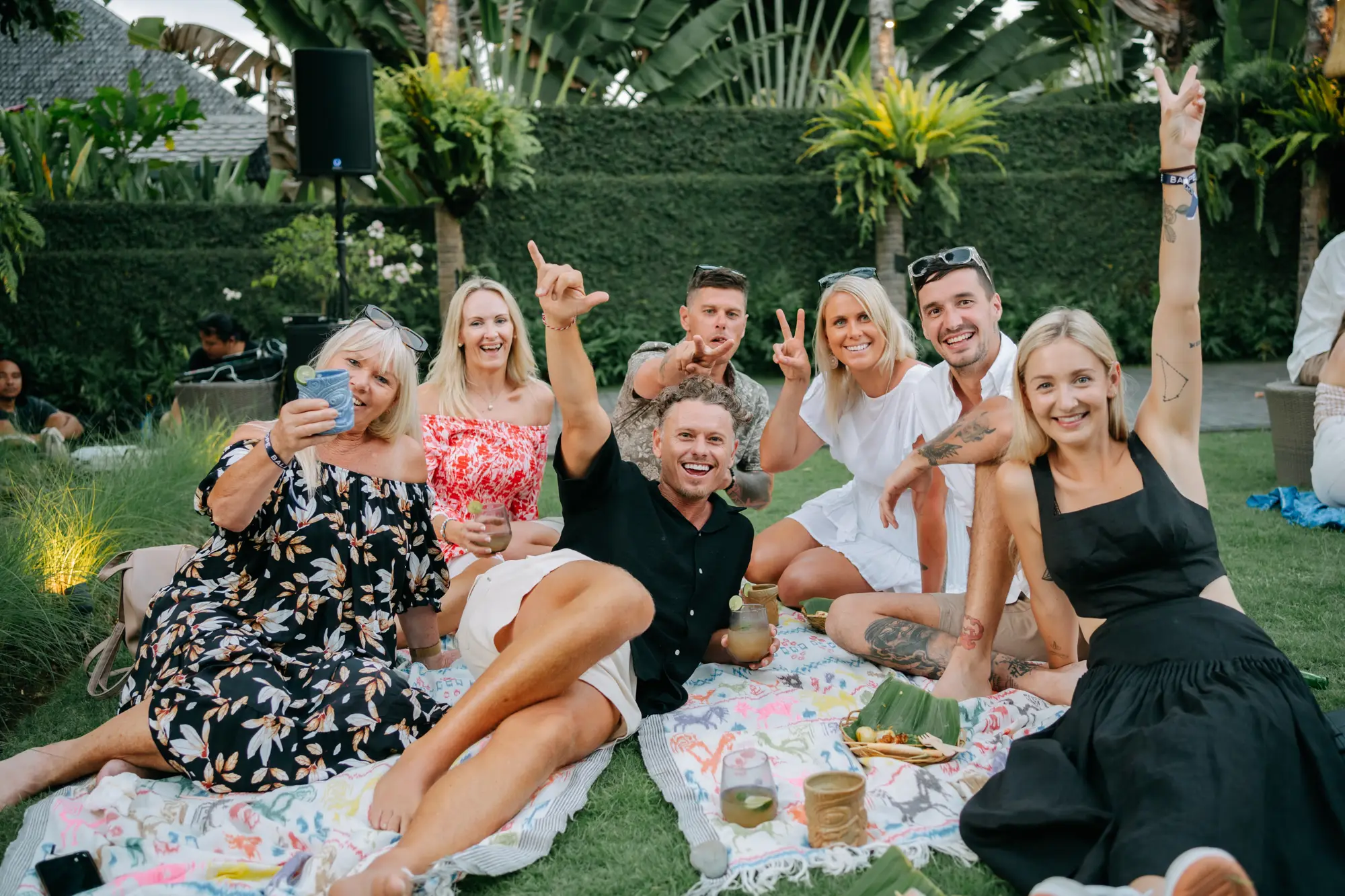 Friends on picnic rugs on the lawn