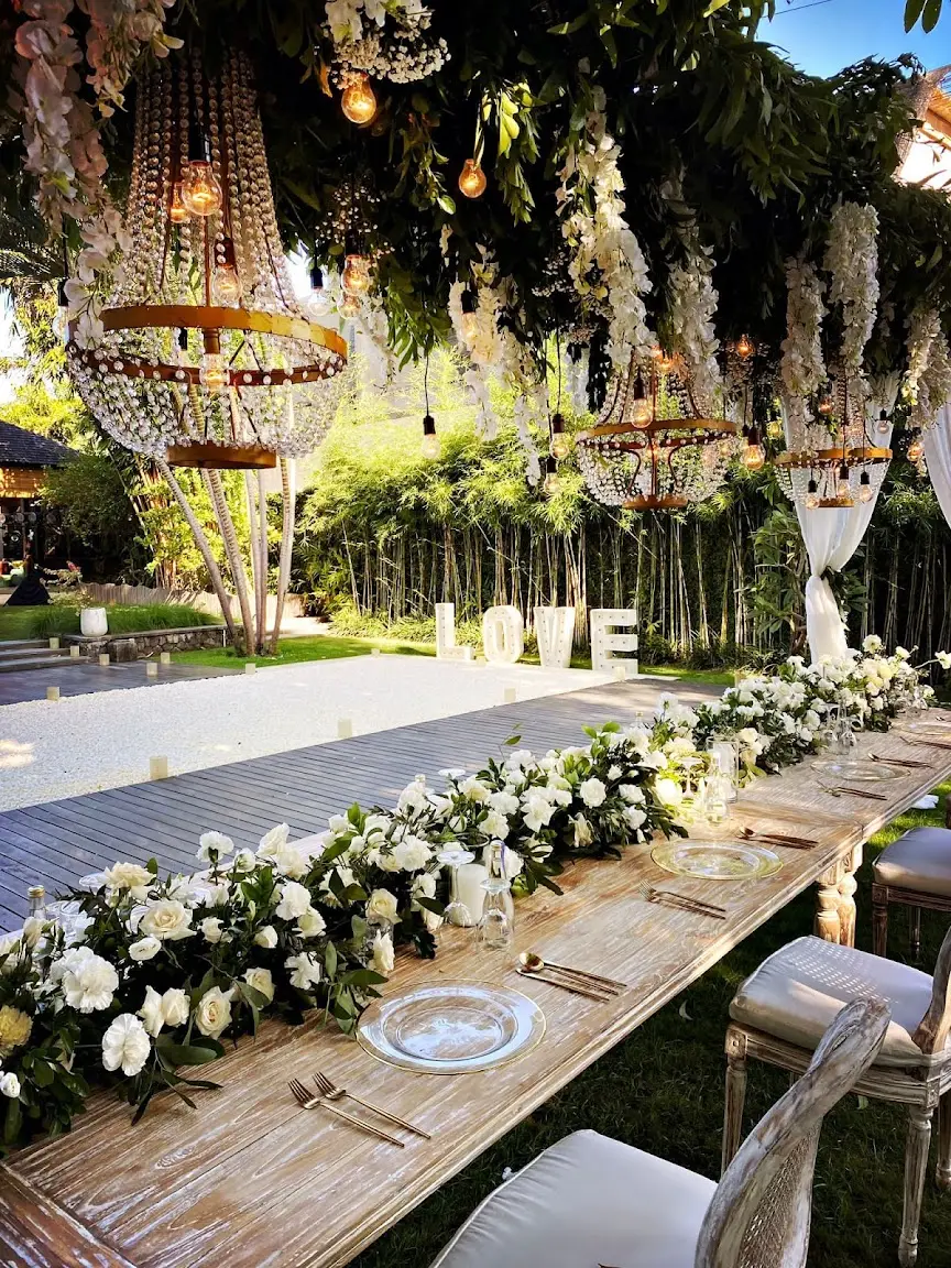A wedding table set with white flowers and a LOVE sign