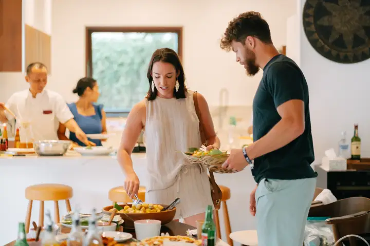 Guests cooking together in the villa kitchen