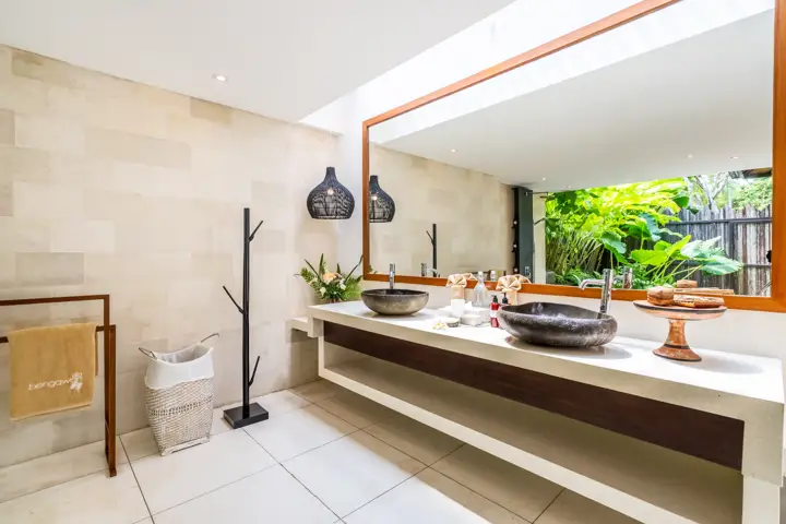 A bathroom with a stone basin and a garden window