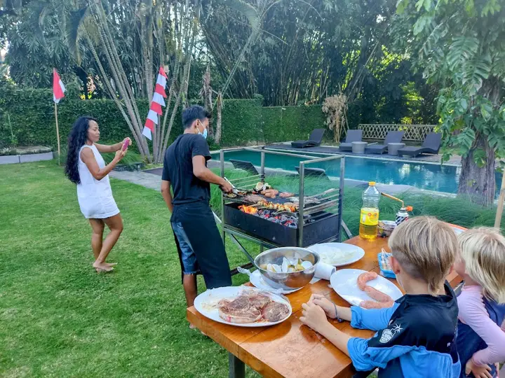 A barbecue lunch on the lawn with children