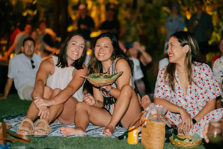 Friends at a party in the garden at night