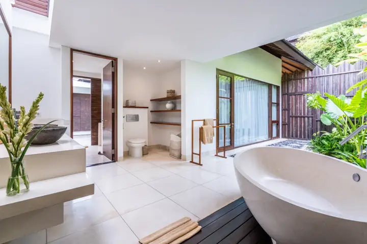 A freestanding bathtub in a bright bathroom