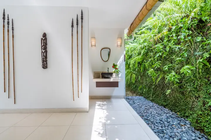 An open-air shower walk with tropical plants