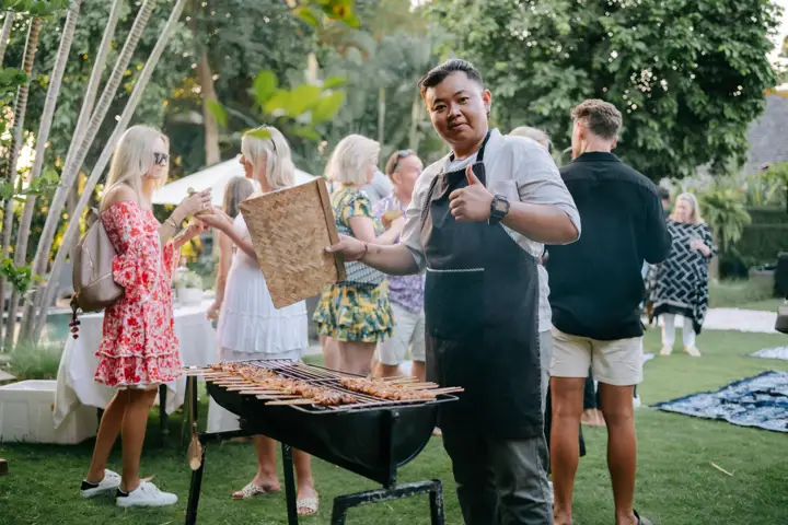 Guests at a barbecue with the villa chef