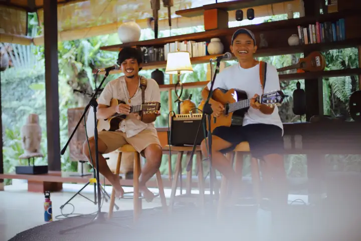Two musicians playing guitar and singing